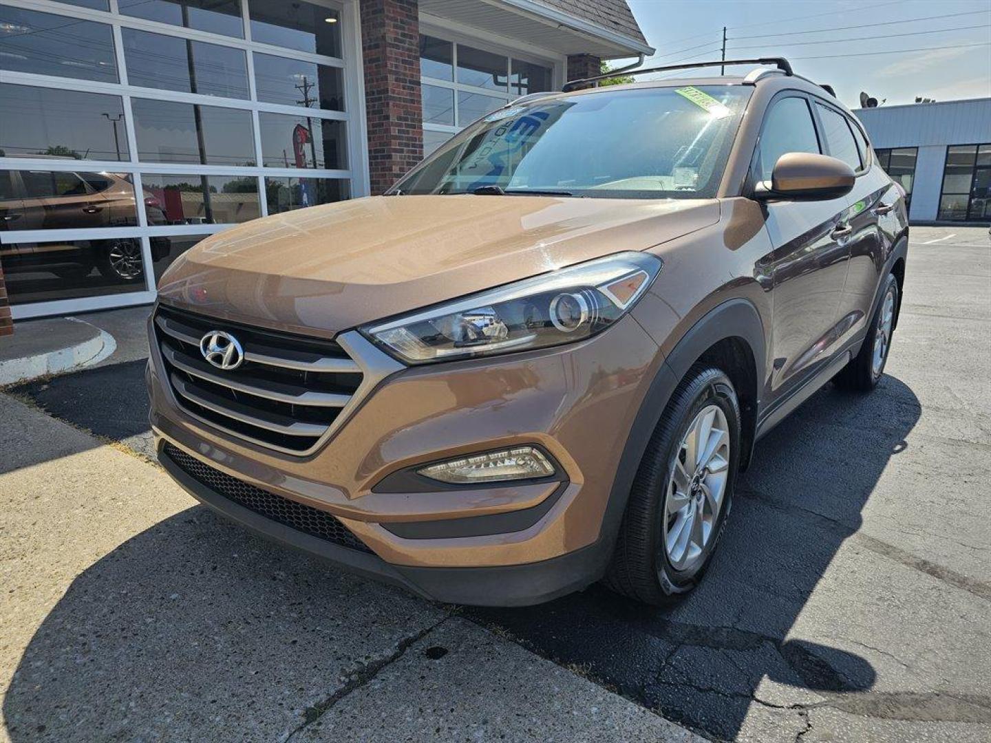 2016 Gold /Tan Hyundai Tucson (KM8J33A40GU) with an 2.0l I-4 DI Dohc Cvvt 2.0 engine, Auto transmission, located at 4163 Bardstown Rd, Louisville, KY, 40218, (502) 266-7677, 38.189991, -85.642418 - The sleek new styling of the redesigned 2016 Hyundai Tucson incorporates what Hyundai calls Fluidic Sculpture 2.0 design language, which suggests it's more of an evolutionary product than a revolutionary one. After all, version 2.0 of anything is just an outgrowth of the original; it's derivative by - Photo#0